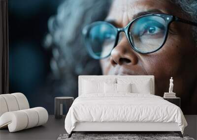 An artistic side view of an elderly person highlighting their curly hair and eyeglasses, setting a deeply reflective and observational mood with texture and clarity. Wall mural