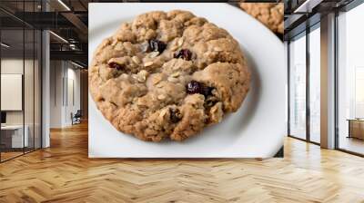 Close-up of one large raisin cookie on a white plate with copy space Wall mural