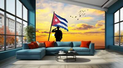 Silhouette of a soldier with the Cuba flag stands against the background of a sunset or sunrise. Concept of national holidays. Commemoration Day. Wall mural