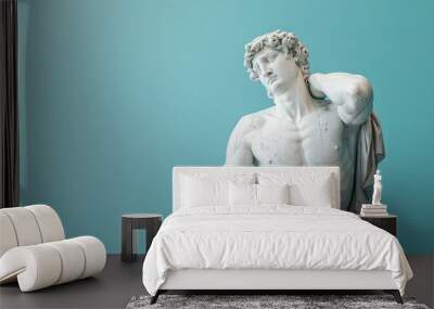 A marble statue of a happy man isolated on pastel blue background Wall mural