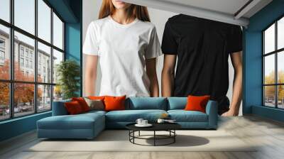 Man and woman wearing blank white and black t-shirts mockup use concept simple and versatile apparel plain and neutral design customizable clothing perfect for showcasing logos or designs casual Wall mural