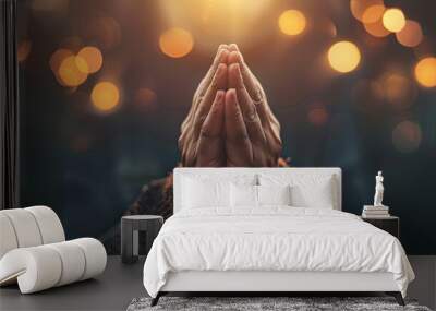 Praying hands with faith in religion and belief in God on dark background Wall mural