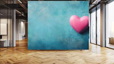 Valentine s Day backdrop featuring a pink heart on a blue surface Conceptual image for Valentine s celebration captured from a flat lay perspective with ample empty space Wall mural