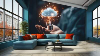 A businessman holds a light bulb with a digital hologram of a cloud and an artificial intelligence concept on a dark background representing an innovative technology business Wall mural