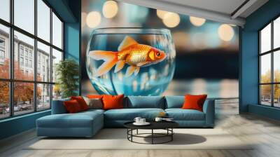 A single goldfish gracefully swims in a clear glass fishbowl with a serene and colorful bokeh background, symbolizing simplicity and tranquility. Wall mural