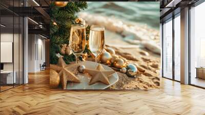 Two champagne glasses on the sand of beach during Christmas or New Year celebration in tropics. Wall mural