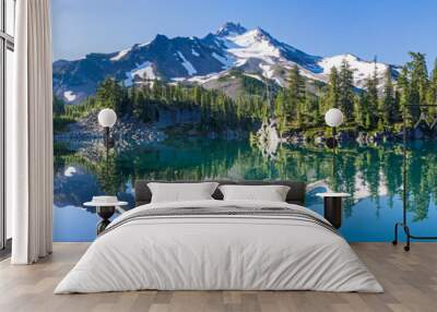 Volcanic mountain in morning light reflected in calm waters of lake. Wall mural