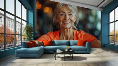 An elderly woman is doing sports in the gym. Wall mural