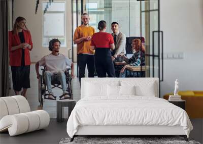 A group of young business people in a modern glass-walled office captures the essence of diversity and collaboration, while two colleagues, including an African American businessman in a wheelchair Wall mural