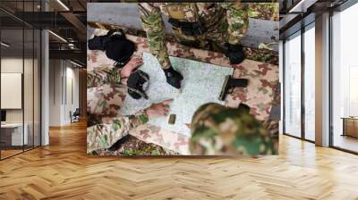 A highly trained military unit strategizes and organizes a tactical mission while studying a military map during a briefing session Wall mural