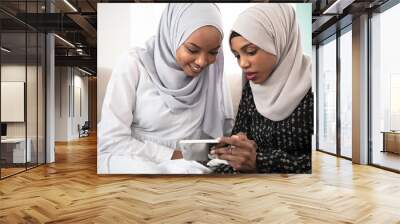 afro girls looking at phone Wall mural