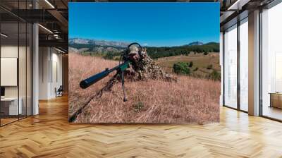 army soldier holding sniper rifle with scope and aiming in forest. war, army, technology and people concept Wall mural