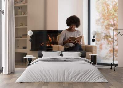 black woman at home reading book Wall mural