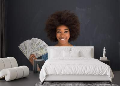 black woman holding money on gray background Wall mural