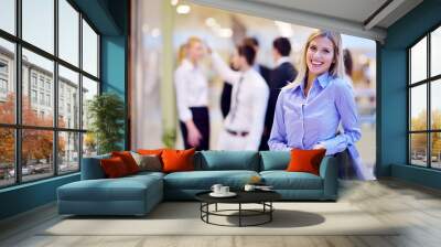 business woman with her staff in background at office Wall mural