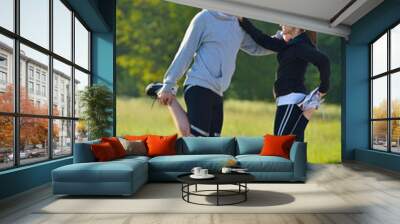 Couple doing stretching exercise  after jogging Wall mural