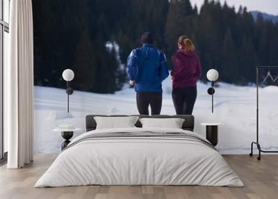 couple jogging outside on snow Wall mural