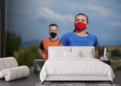 couple running in nature wearing mask Wall mural