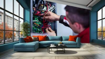 electrician engineer working with electric cable wires Wall mural