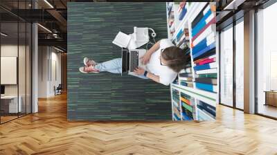 female student study in library, using tablet and searching for Wall mural