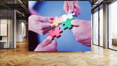 Group of business people assembling jigsaw puzzle Wall mural