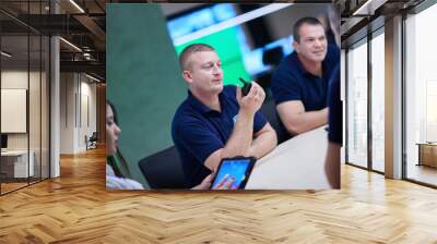 Group of security guards sitting and having briefing Wall mural