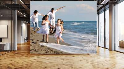 happy family playing with dog on beach Wall mural