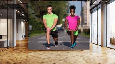 jogging couple warming up and stretching in the city Wall mural