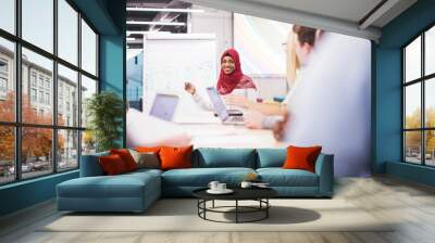 Muslim businesswoman giving presentations at office Wall mural