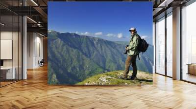 Nature photographer with digital camera Wall mural