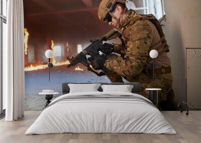 soldier in action near window changing magazine and take cover Wall mural