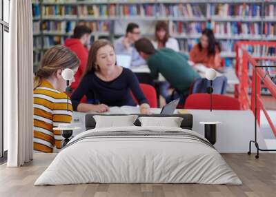 the student uses a notebook and a school library Wall mural