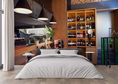 Wine bottles on a wooden shelf. Wall mural