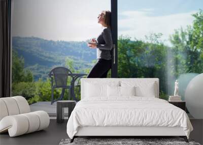 woman eating breakfast in front of her luxury home villa Wall mural