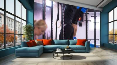 young athletes doing pull ups on the horizontal bar Wall mural