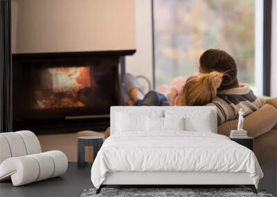 Young couple  in front of fireplace Wall mural