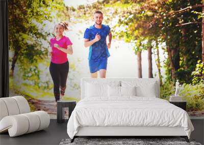 young couple jogging on sunny day at nature Wall mural