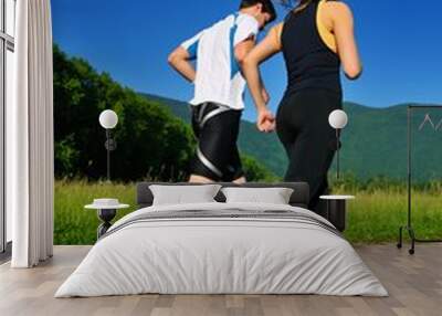 Young couple jogging Wall mural