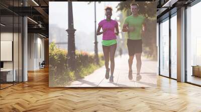 young multiethnic couple jogging in the city Wall mural