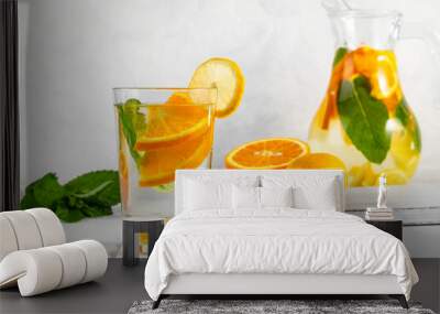 Citrus drink with lemon, orange and mint. Healthy and healthy drink in a transparent glass with copy space Wall mural