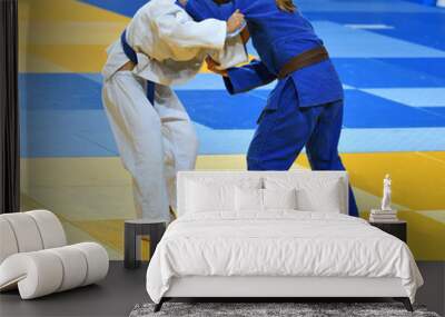 Two Girls judoka in kimono compete on the tatami  Wall mural