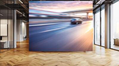 Car driving on freeway at sunset, motion blur Wall mural