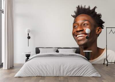 Studio portrait of a black smiling handsome man Wall mural