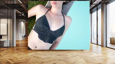 Attractive hispanic young woman lying by the pool wearing elegant crochet bikini Wall mural