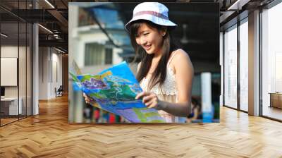 little chinese asian tourist girl looking at her map Wall mural