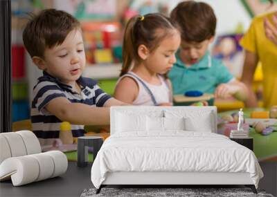 Childs are playing with play clay in classroom Wall mural