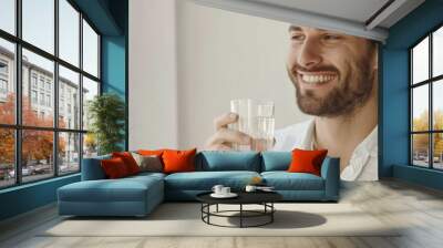 Man smiling and holding a glass of water Wall mural