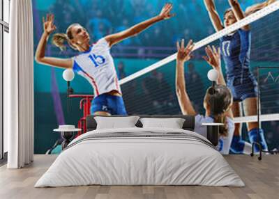 Female professional volleyball players in action on grand court Wall mural