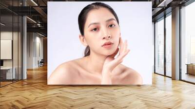 Attractive young Asian woman with youthful skin. Facial care, facial treatment, woman beauty skin isolated on white background. cosmetology, skin beauty and cosmetic concept Wall mural