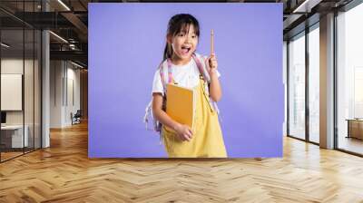 cute asian schoolgirl posing on purple background Wall mural